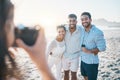 Happy, photo and friends at the beach with a photographer for summer memory, holiday or bonding. Smile, camera and a Royalty Free Stock Photo