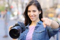 Happy photographer pointing at camera