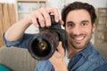 Happy photographer working in studio