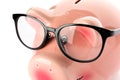 Happy piggy bank with glasses isolated on white background, closeup Royalty Free Stock Photo