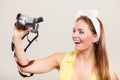 Happy pin up girl woman filming with camcorder. Royalty Free Stock Photo