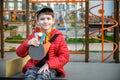 Happy ping pong player think about a game. young boy sitting after match on a tennis table outdoors Royalty Free Stock Photo