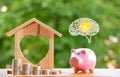 Happy Pink Piggy Bank and Home wooden in close-up and coins stack in the nature background, Saving ideas  and investment budget, B Royalty Free Stock Photo