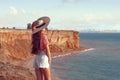 Happy pinup girl outdoor portrait. Travel vacation fun summer woman with hat enjoying freedom over Black sea. Carefree girl Royalty Free Stock Photo