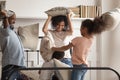 Happy african parents and kids having pillow fight on bed Royalty Free Stock Photo