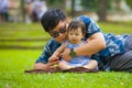 Happy playful Asian Japanese man as loving father enjoying sweet and beautiful baby girl daughter sitting together playing on Royalty Free Stock Photo