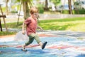 happy playful boy fun laugh smiling kid enjoy playing activity at the playground outdoor park summer Royalty Free Stock Photo