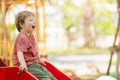 happy playful boy fun laugh smiling kid enjoy playing activity at the playground outdoor park summer Royalty Free Stock Photo