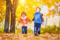 Happy playful children in the autumn park Royalty Free Stock Photo