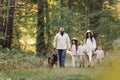 Happy playful family runing in park with pet. Young mom, dad having fun with three kids and big dog outdoors. Parents Royalty Free Stock Photo