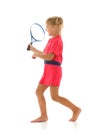 A little girl holds a tennis racket in her hands. Game, sports concept. Royalty Free Stock Photo