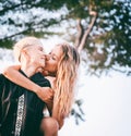 Happy playful girlfriends in love on piggyback hug and kissing Royalty Free Stock Photo