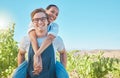 Happy and playful interracial farming couple with smile bonding with piggy back. Business people, man and woman Royalty Free Stock Photo