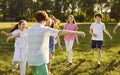 Happy playful kids friends playing active outdoor games in the summer park. Royalty Free Stock Photo