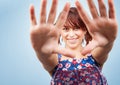 Happy playful teen woman looking through hands