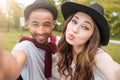 Happy playful young couple making selfie in park Royalty Free Stock Photo