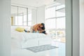 Happy playful young mixed race woman kneeling on top of her boyfriend in bed at home. Romantic couple bonding in their Royalty Free Stock Photo