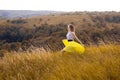 Happy playful young pretty girl running on the field with green, yellow wheat on the way to good life.Happy adventure in summer, s