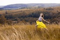 Happy playful young pretty girl running on the field with green, yellow wheat on the way to good life.Happy adventure in summer, s