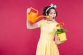 Happy playful young woman watering flowers in pot Royalty Free Stock Photo