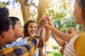 Happy, playing and children with a high five for a game, support and team building at a park. Smile, together and Royalty Free Stock Photo