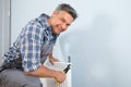 Happy plumber fixing radiator Royalty Free Stock Photo