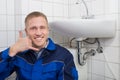 Happy Plumber Making Call Me Gesture