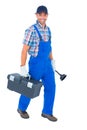 Happy plumber with plunger and toolbox walking on white background