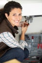 happy plumber woman installing pipes