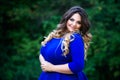 Happy plus size fashion model in blue dress outdoors, happiness beauty woman with professional makeup and hairstyle