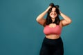 Happy plus size positive woman. Happy body positive concept. I love my body. Attractive overweight woman posing on camera in the