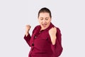 Happy plus size woman celebrating and dancing for female power. Curvy overweight lady having fun on gray background