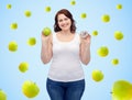 Happy plus size woman choosing apple or donut Royalty Free Stock Photo