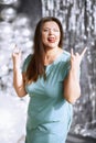 Happy plus size woman showing rock and roll hand gesture