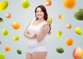 Happy plus size woman in underwear with apple Royalty Free Stock Photo