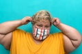 Happy plus size woman wearing face mask portrait - Curvy overweight model having fun posing in front camera Royalty Free Stock Photo