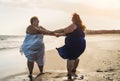 Happy plus size women dancing on the beach - Curvy overweight girls having fun during vacation in tropical destination