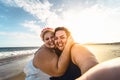 Happy plus size women taking selfie on the beach - Curvy overweight girls having fun during vacation in tropical destination