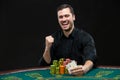 Happy poker player winning and holding a pair of aces Royalty Free Stock Photo