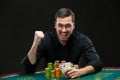Happy poker player winning and holding a pair of aces Royalty Free Stock Photo