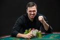 Happy poker player winning and holding a pair of aces Royalty Free Stock Photo