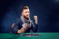 Happy poker player winning and holding a pair of aces Royalty Free Stock Photo