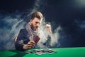 Happy poker player winning and holding a pair of aces Royalty Free Stock Photo