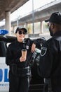 Happy policewoman with paper cup looking Royalty Free Stock Photo