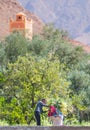 A happy, poor old lady farmer woman with old traditional muslin scarf and dress in Morocco village