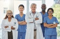 Happy portrait, arms crossed and group of doctors standing together in hospital. Face, teamwork and confident medical Royalty Free Stock Photo