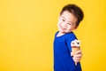 Kid cute little boy attractive laugh smile playing holds and eating sweet chocolate ice cream waffle cone Royalty Free Stock Photo