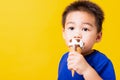 Kid cute little boy attractive laugh smile playing holds and eating sweet chocolate ice cream waffle cone Royalty Free Stock Photo