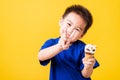 Kid cute little boy attractive laugh smile playing holds and eating sweet chocolate ice cream waffle cone Royalty Free Stock Photo