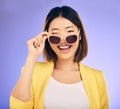 Happy, portrait of asian woman wink with glasses in studio, purple background and fashion. Face, female model and blink Royalty Free Stock Photo